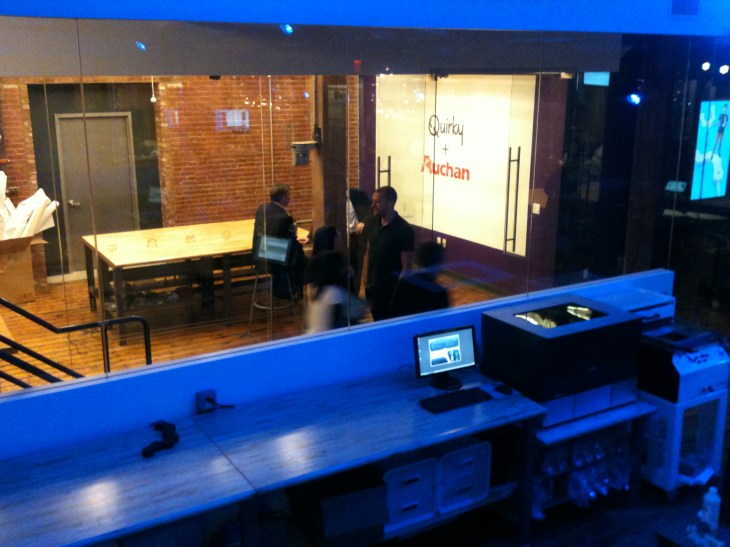 Behind one of three 3D-printers, a meeting room with a Quirky + Auchan illustration